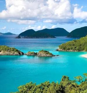 a view of a beach with islands in the water