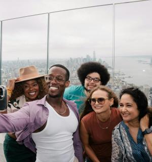 a group of people posing for a picture at the top of a building