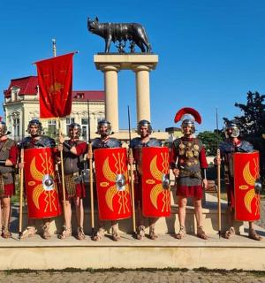 a group of men in uniform standing in front of a statue