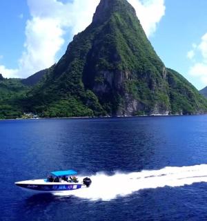 a boat in the water with a mountain in the background