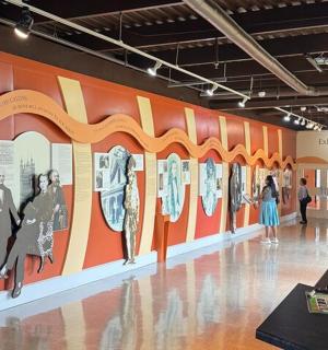 a museum with a wall with pictures offamous people