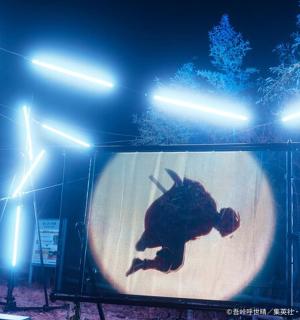 a person on a screen on a stage with lights