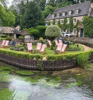 a group of chairs sitting on the edge of a river