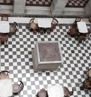 an overhead view of a checkered floor with tables and chairs