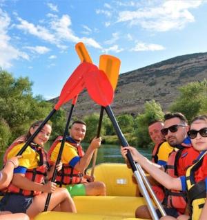a group of people on a raft on the water