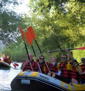 a group of people in a raft on a river