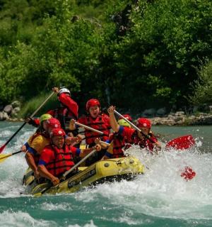 a group of people in a raft in a river