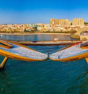 two boats in the water with a city in the background