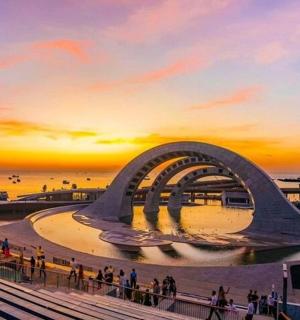 a rendering of a building with people walking around it