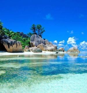a beach with rocks and water in the ocean