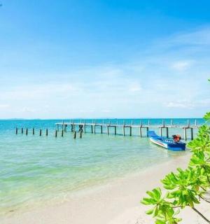 a boat on a beach next to a pier