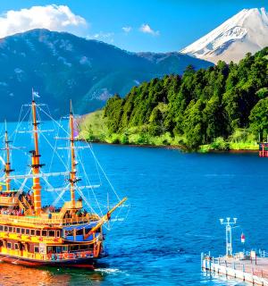 a boat on a lake with a mountain in the background