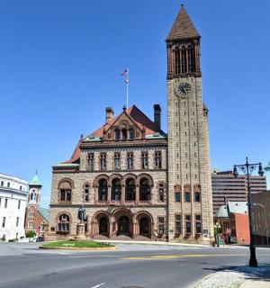 a large building with a clock tower on a street