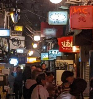 a crowd of people in a street with signs
