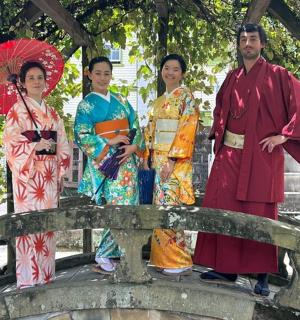 a group of people standing on a bridge holding umbrellas