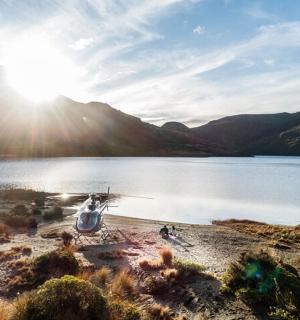 a view of a lake with the sun shining