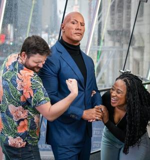 dva muži a žena tančící na budově