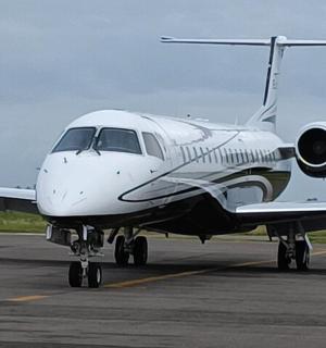 a small white airplane sitting on a runway