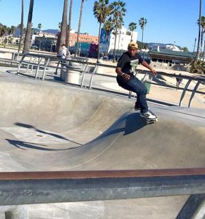 a man riding a skateboard on a ramp at a skate park