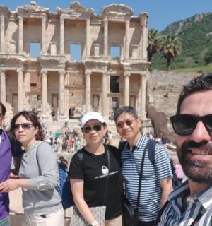 a group of people standing in front of the coliseum