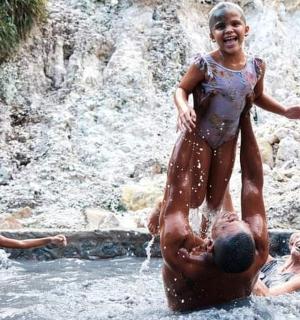 a group of people playing in the water