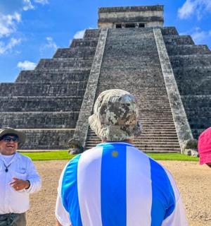 a group of people standing in front of a pyramid