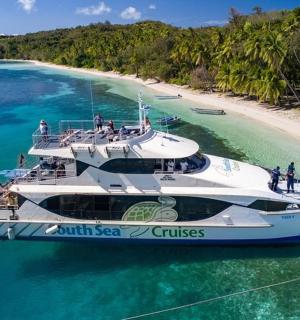 a boat in the water next to a beach