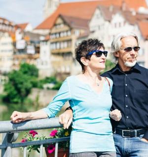 a man and a woman standing next to a railing