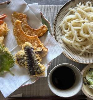 a plate of food with noodles and a cup of coffee