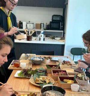 a group of people sitting around a table eating food