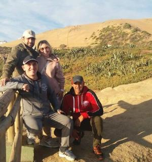 a group of people posing for a picture on a mountain