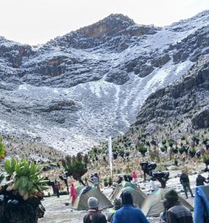 a group of people looking at a snowy mountain