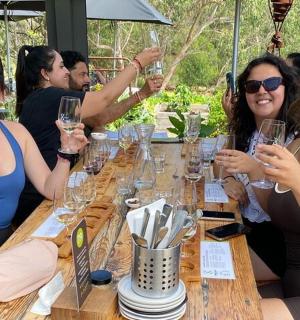 three women sitting at a table with wine glasses