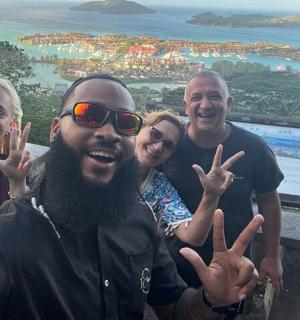 a group of people giving the peace sign with their hands