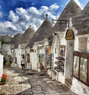 an alley with a woman walking down a street