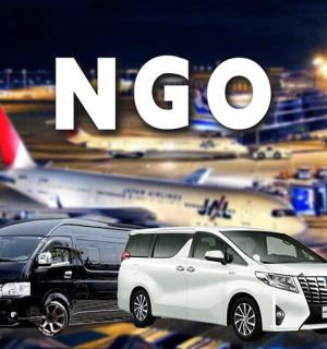 two cars parked at an airport with an airplane