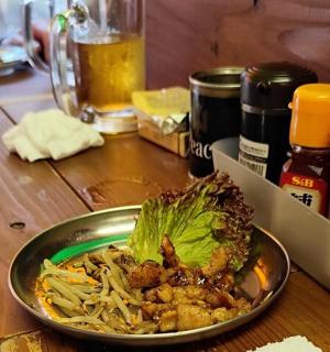 a plate of food on a wooden table with a bowl of food
