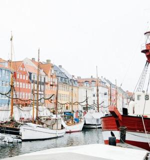 a group of boats docked in a harbor with buildings
