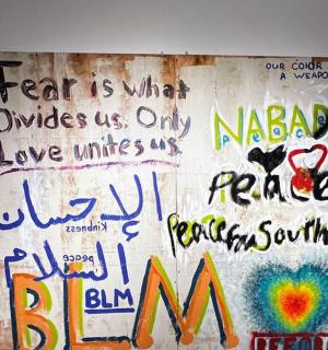 a wall covered in graffiti with writing on it