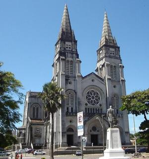 a large church with two towers on a street