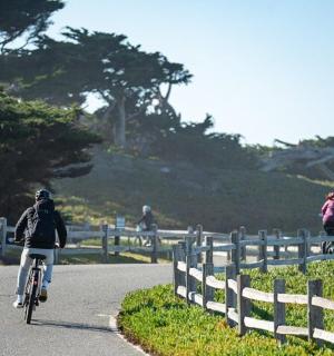 a person riding a bike down a road