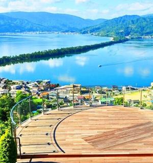 a view of a large lake with a wooden boardwalk
