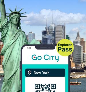 an electronic sign in front of the statue of liberty