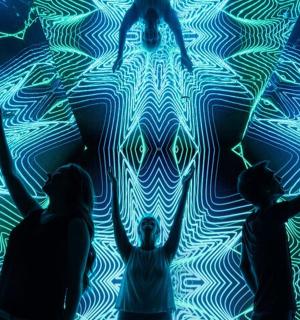 a group of people standing in front of a painting