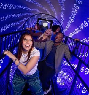 a group of people on a staircase in a blue tunnel