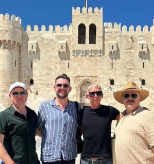 a group of people standing in front of a castle