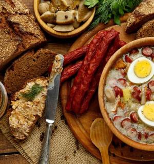 a table with a bowl of food with eggs and bread