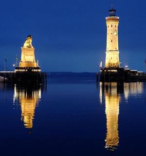 a lighthouse and a statue in the water