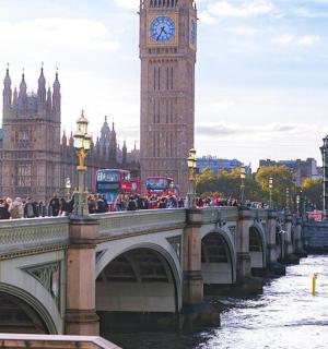 a bridge over a river with a clock tower