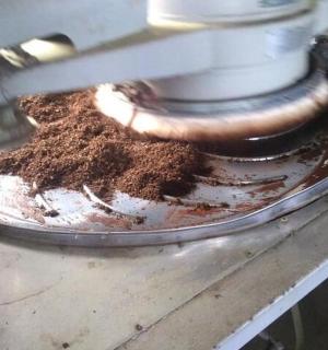 a pile of chocolate is being made in a machine
